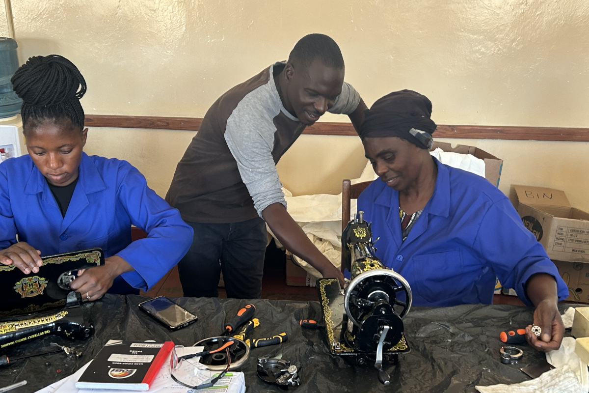 Roy teaching sewing machine maintenance