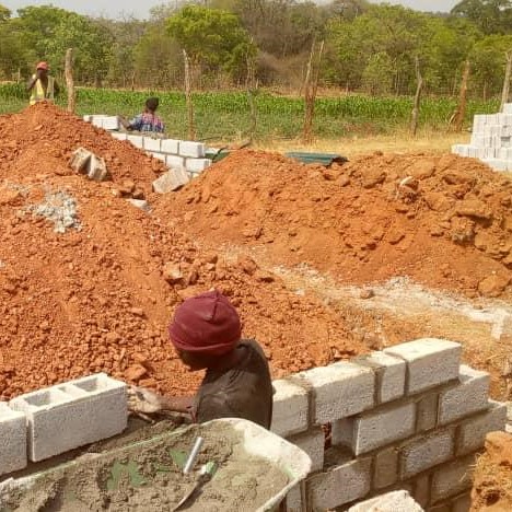 Laying the first bricks for the walls