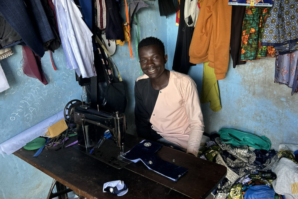 Joram Mahing tailoring at his machine